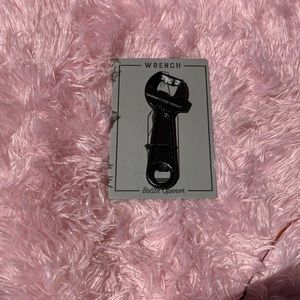 Black metal wrench bottle opener